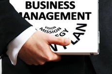 Picture of a man carrying a business management folder