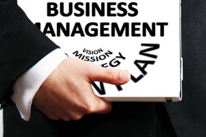 Management system assessment Picture of a man carrying a business management folder