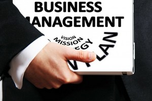 Picture of a man carrying a business management folder